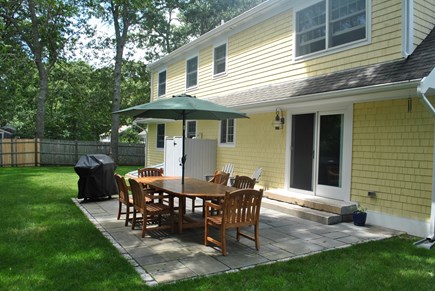 Osterville Cape Cod vacation rental - Private backyard with patio, gas grill, and outdoor shower
