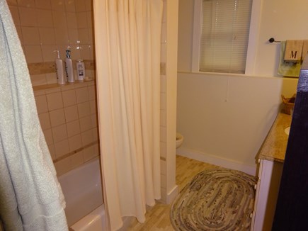 East Orleans Cape Cod vacation rental - Full bath with tub shower combo in lower level bedroom hallway.