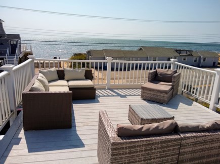 Dennisport Cape Cod vacation rental - Relax on the second story deck with views of the ocean.