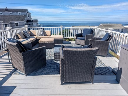 Dennisport Cape Cod vacation rental - Relax on the second story deck with views of the ocean.