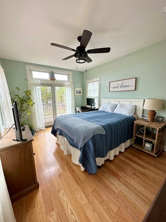 Eastham Cape Cod vacation rental - Primary bedroom with queen bed and view looking towards the bay.