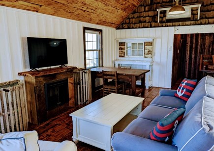 Falmouth Cape Cod vacation rental - Living and dining area with fireplace.