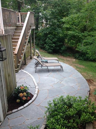 Eastham, Located on Schoolhouse Pond Cape Cod vacation rental - Bluestone patio with lounge chairs overlooking the pond