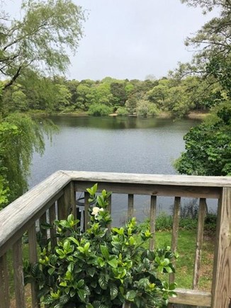 Eastham, Located on Schoolhouse Pond Cape Cod vacation rental - View of Schoolhouse Pond from the deck with dining table.