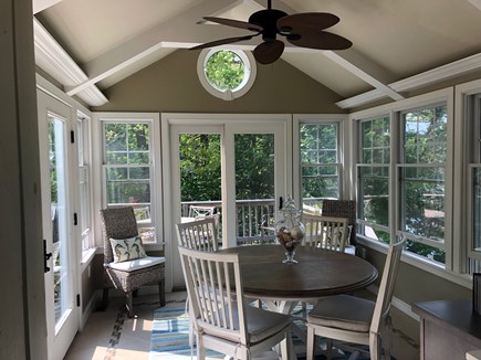 Eastham, Located on Schoolhouse Pond Cape Cod vacation rental - Sunroom with french entry doors and windows all around.