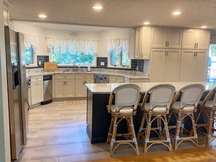 Falmouth Heights Cape Cod vacation rental - 5 swivel stools; open concept to LR & DR; sliders to deck & BBQ;