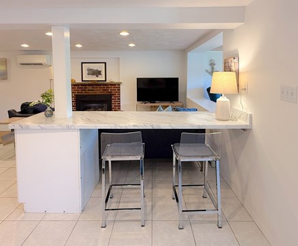 East Falmouth  Cape Cod vacation rental - A counter for meal/work with a mini-split, gas FP, & TV in the LR