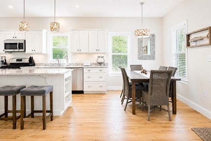 Dennis, Mayflower Beach Cape Cod vacation rental - Kitchen and dining area with 8 chairs-open to den