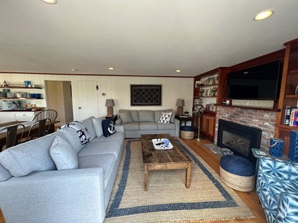 East Orleans, Mill Pond  Cape Cod vacation rental - Living room with gas fireplace, TV, and sliders to deck