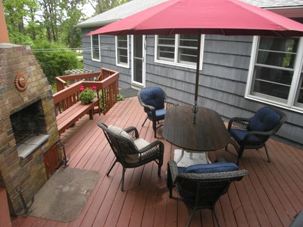 E Orleans / Orleans Village Cape Cod vacation rental - Back deck with built-in fireplace. New padded wicker seating (6).