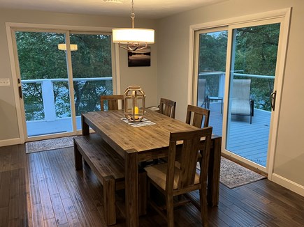 Barnstable Cape Cod vacation rental - Open kitchen and dining area with deck access
