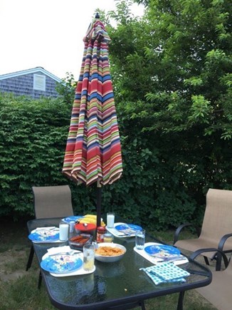 Dennis Cape Cod vacation rental - Sunny large yard with  gas grill, dining table and chairs