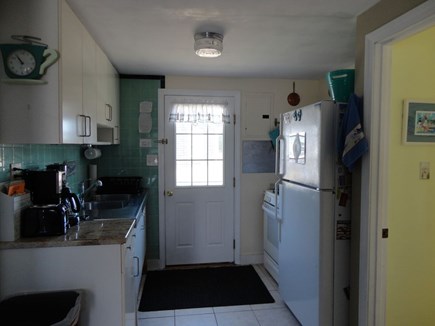 West Dennis Cape Cod vacation rental - Kitchen with door to back yard and more outdoor seating