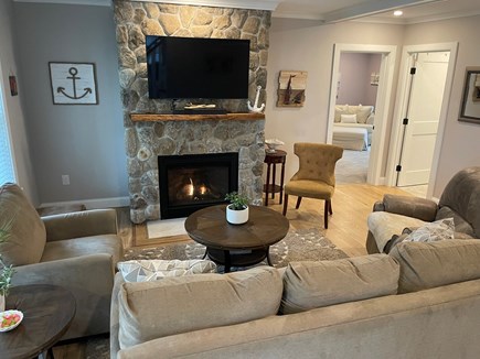 Wellfleet Cape Cod vacation rental - Open living room with gas stone fireplace, reclining rocker.