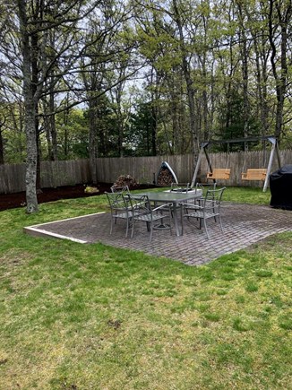 West Yarmouth Cape Cod vacation rental - Patio for dining and grilling. Adult swings and fire pit area