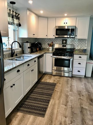 South Dennis Cape Cod vacation rental - New kitchen with gas stove, dishwasher, table for 6