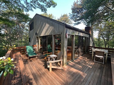 Wellfleet Cape Cod vacation rental - Main deck with banquettes, chaise, and dining table.