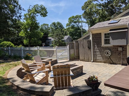 Harwich Cape Cod vacation rental - Fire pit, and tv. Outdoor shower is to the left of the tv.