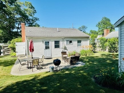 Plymouth, Priscilla Beach MA vacation rental - Back patio with dinning  table seating and relaxing wicker set!