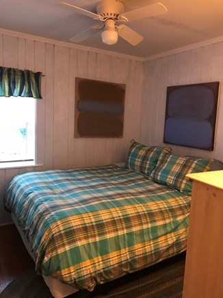 Wellfleet Cape Cod vacation rental - Queen bedroom with smart TV, artwork, closet and dresser.