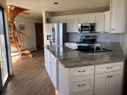 Truro Cape Cod vacation rental - Another view of the kitchen, glass doors open to the large deck