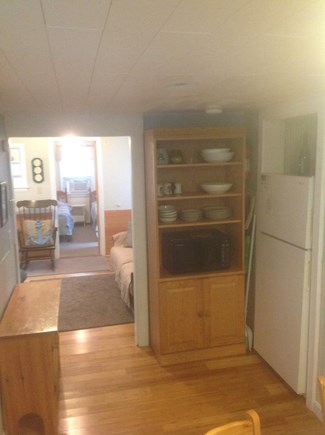 Dennis Port Cape Cod vacation rental - Kitchen storage and refrigerator w/view to living room