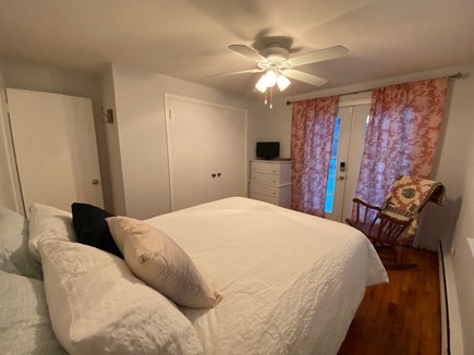Hyannis Cape Cod vacation rental - Master bedroom with queen bed and access to back deck and yard