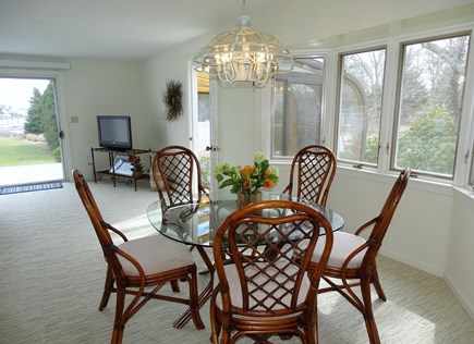 Harwich Port Cape Cod vacation rental - Dining area from kitchen, showing sliders to deck, harbor view