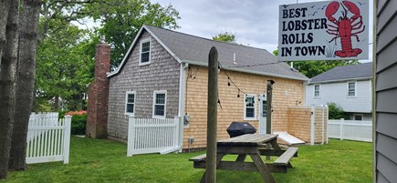 Dennis Cape Cod vacation rental - Backyard with grill, picnic table, and outdoor shower