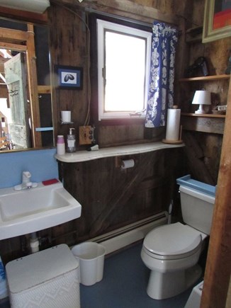 South Truro Cape Cod vacation rental - Rustic bathroom with lots of light and storage.