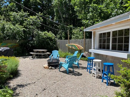 Dennis Cape Cod vacation rental - Private side yard with fireplace and bar area