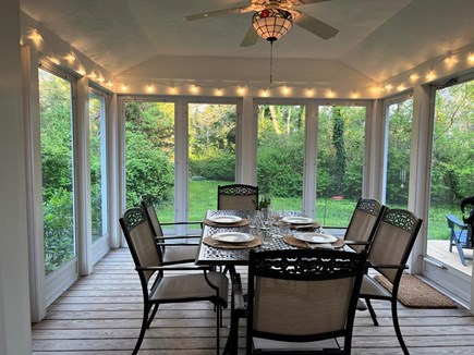 North Eastham Cape Cod vacation rental - Screened in porch. Large deck with gas grill & table beside it.
