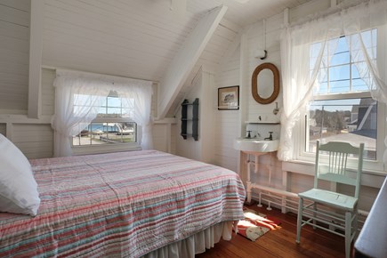 North Falmouth, Megansett Cape Cod vacation rental - The Harbor Side Room with a queen bed and wash sink and mirror.