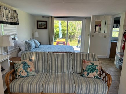Wellfleet Cape Cod vacation rental - View of couch and Queen bed looking out to slider