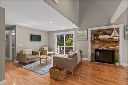 Dennis Port Cape Cod vacation rental - Living room features a TV and sliding doors out to the back deck