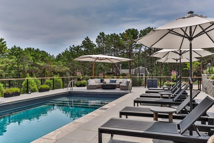 Eastham Cape Cod vacation rental - The pool deck offers multiple options for relaxation.