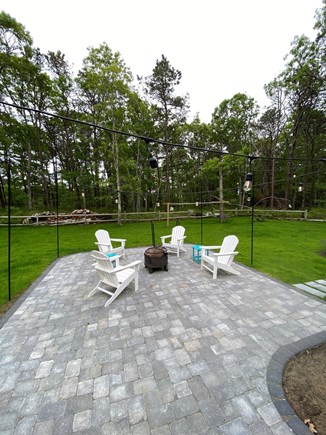 South Yarmouth Cape Cod vacation rental - Sit around the firepit on this large outdoor patio space.