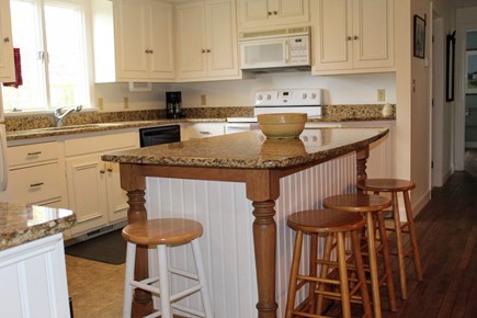 Chatham Cape Cod vacation rental - Step up to kitchen with large granite top center island