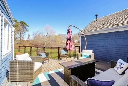 South Yarmouth Cape Cod vacation rental - Spacious deck w tabletop s'more station off in-law living room