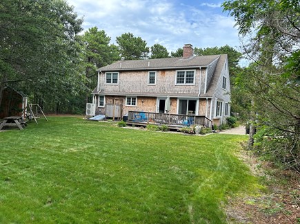 Eastham Cape Cod vacation rental - Deck with table, chairs and BBQ overlooking sizable yard.