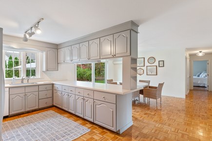 East Falmouth Cape Cod vacation rental - Open kitchen and dining area with slider to patio
