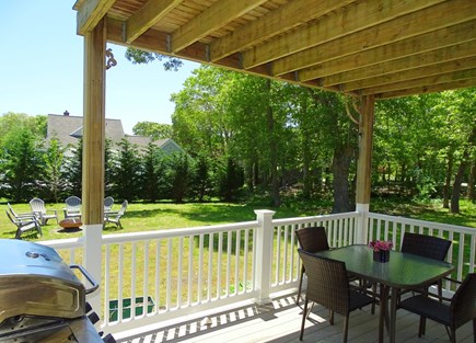 East Falmouth Cape Cod vacation rental - Shaded deck with grill and seating area, slider into main living