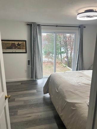 Falmouth Cape Cod vacation rental - Bedroom w/ slider to back yard & deck
