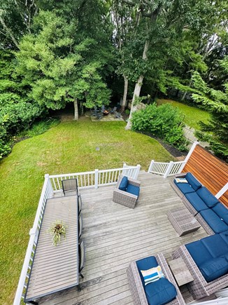 Marion MA vacation rental - Back yard with deck overlooking Aucoot Cove with ample seating.