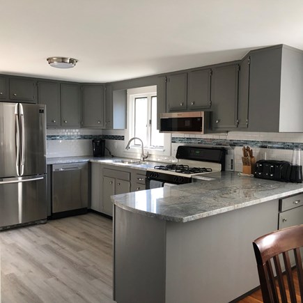 Bayside in East Dennis Cape Cod vacation rental - Kitchen with granite counter andalong with tired backsplash