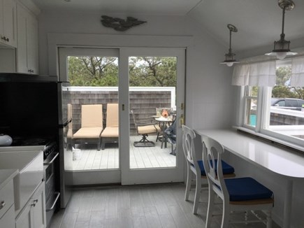 Wellfleet Oceanfront Home Cape Cod vacation rental - Kitchen w Picture window to Ocean, & French Door to Dining Deck
