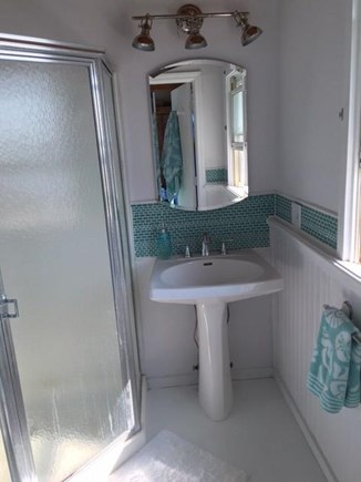 Wellfleet Oceanfront Home Cape Cod vacation rental - Master bath white marble floor, pedestal sink, corner shower,