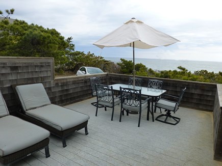 Wellfleet Oceanfront Home Cape Cod vacation rental - Lower deck lounges. Newer Dining 
set seats 8