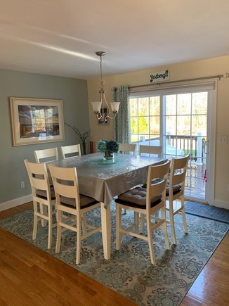 Falmouth Cape Cod vacation rental - Kitchen dining with sliders to deck, patio and hot tub
