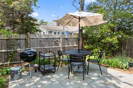 Dennis Port Cape Cod vacation rental - Back patio with umbrella, gas, and charcoal grills